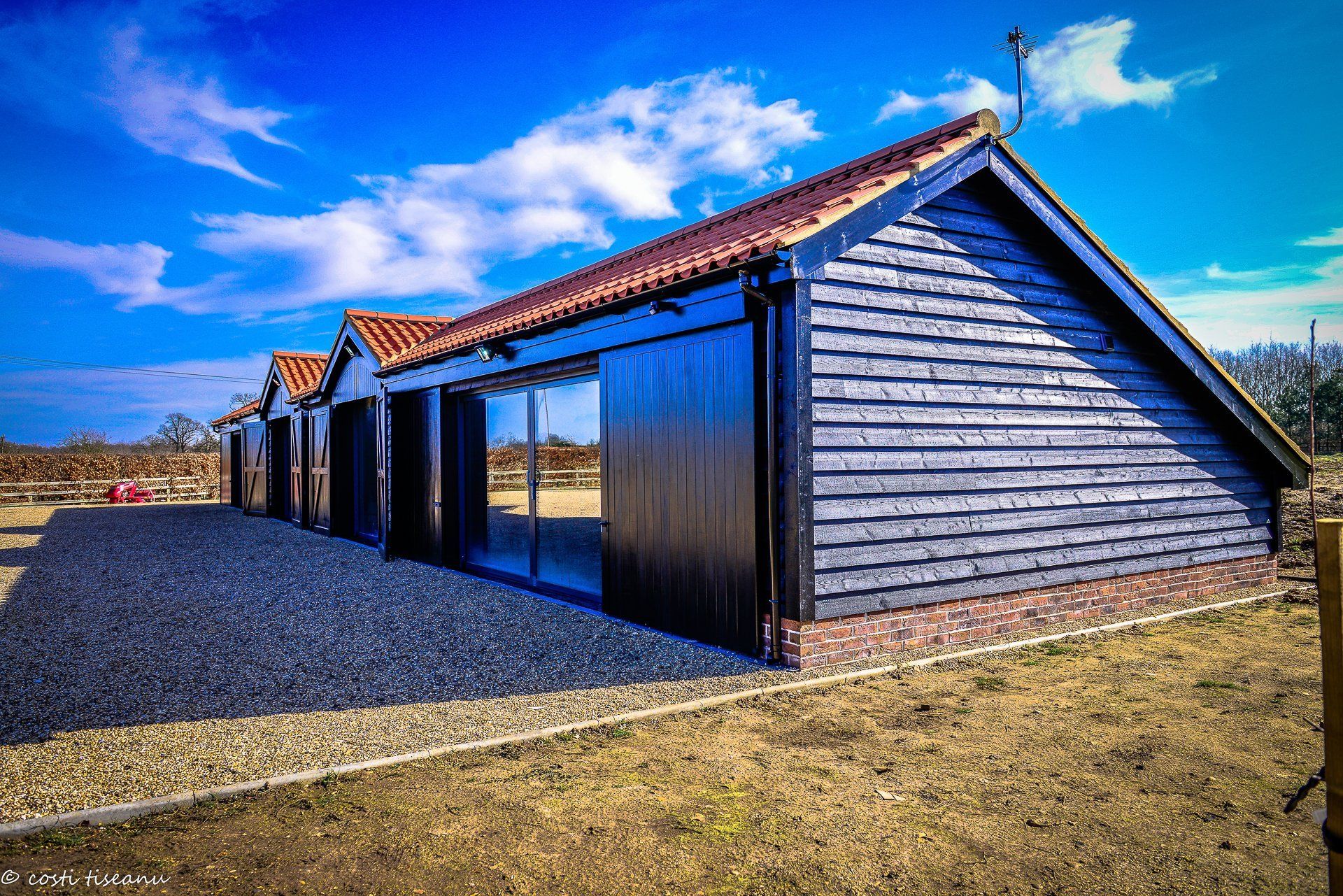 Glazed doors and dark cladding on the completed Big Barn