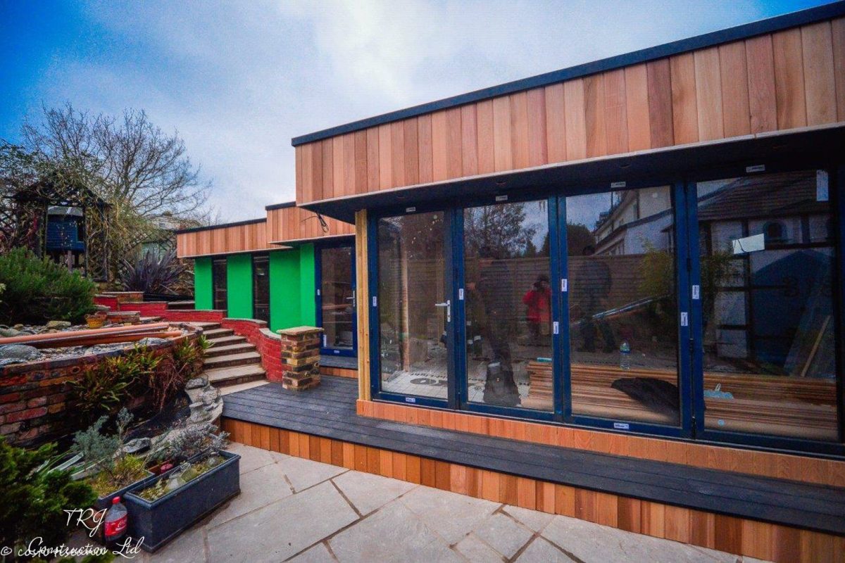 Red cedar garden room constructed with SIP panels, showcasing a modern and sustainable design