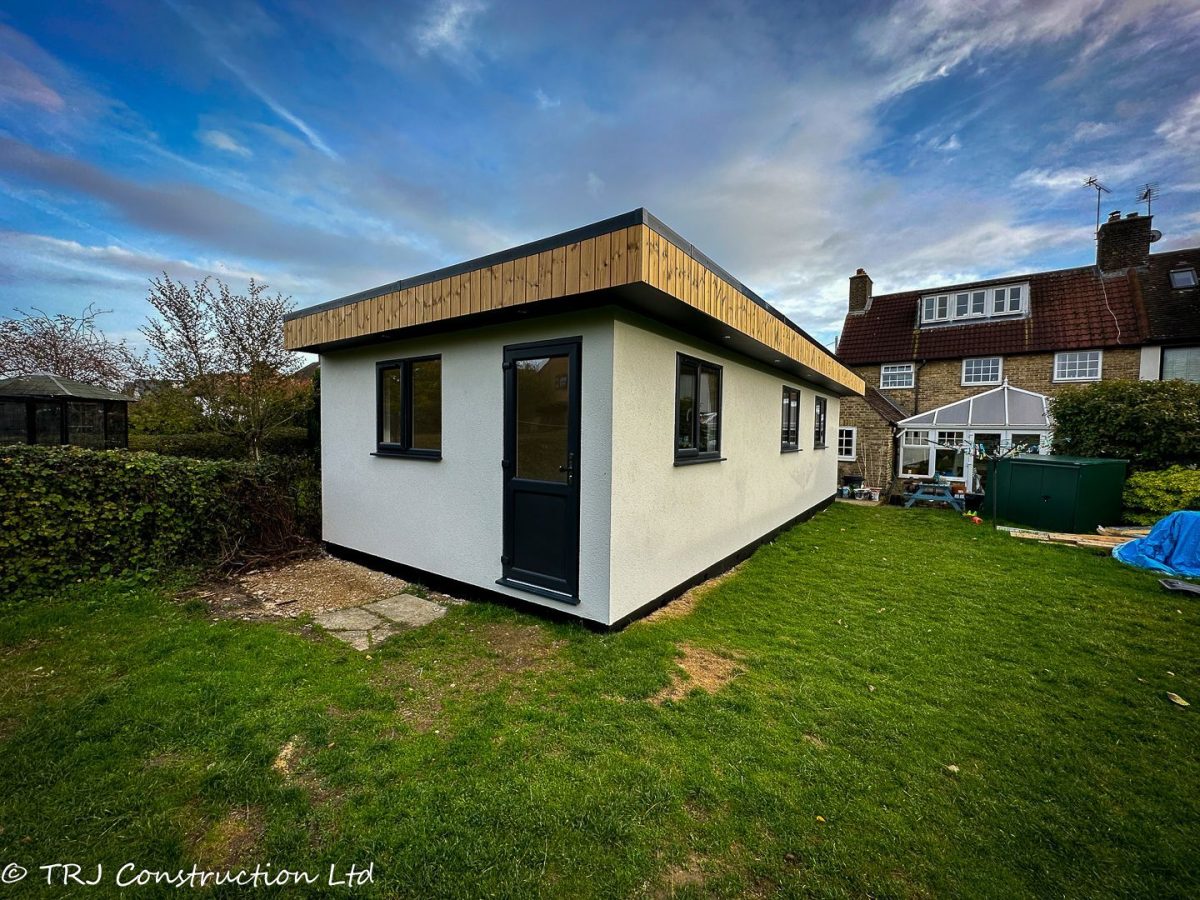 Completed detached garden annexe in Epping with rendered walls and glazed doors