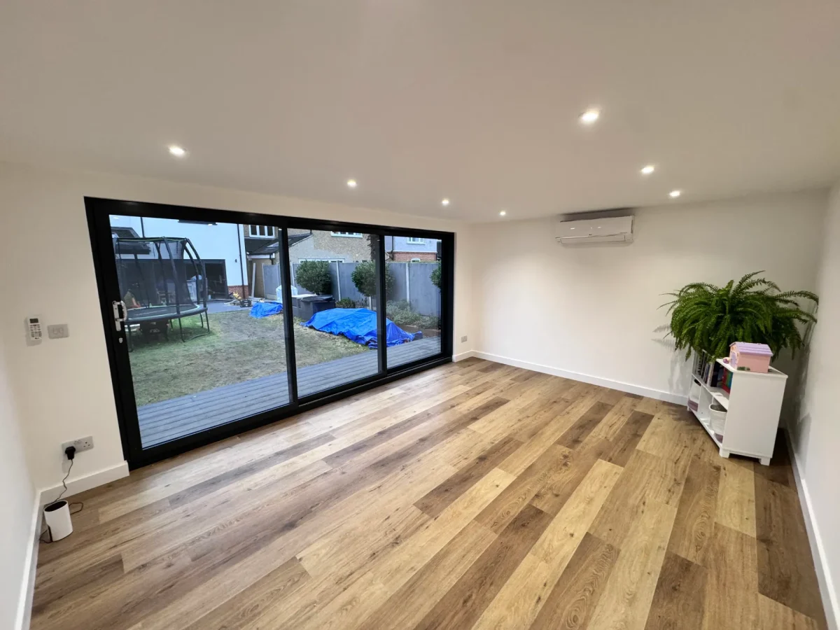 Finished garden-room interior with timber flooring and wide glazed doors